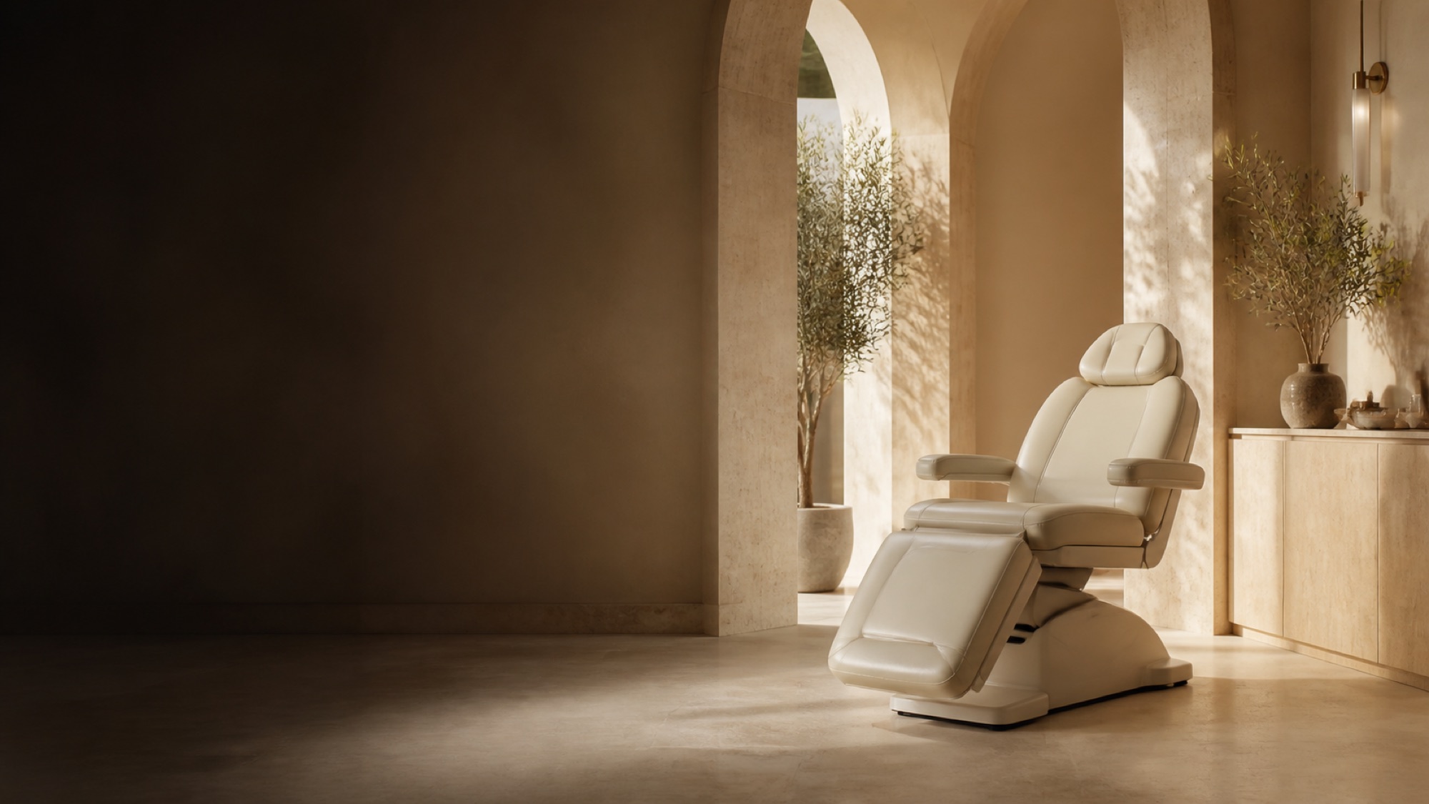 An immaculate empty treatment chair in a sunlit room with stone arches